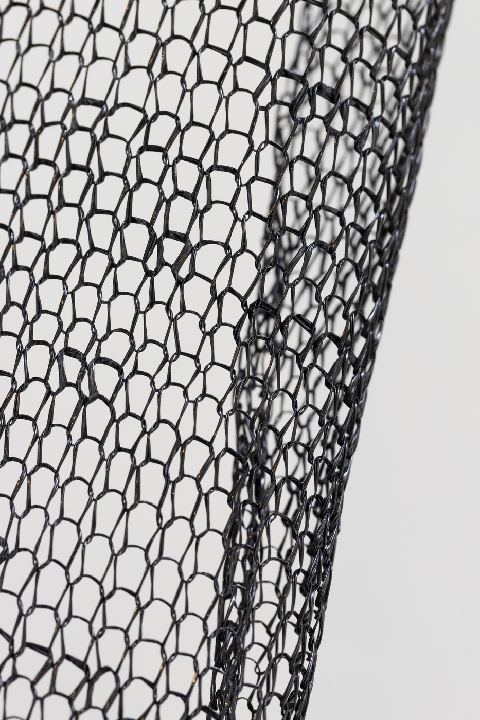 Close-up of black woven mesh sculpture by Vanessa Enriquez