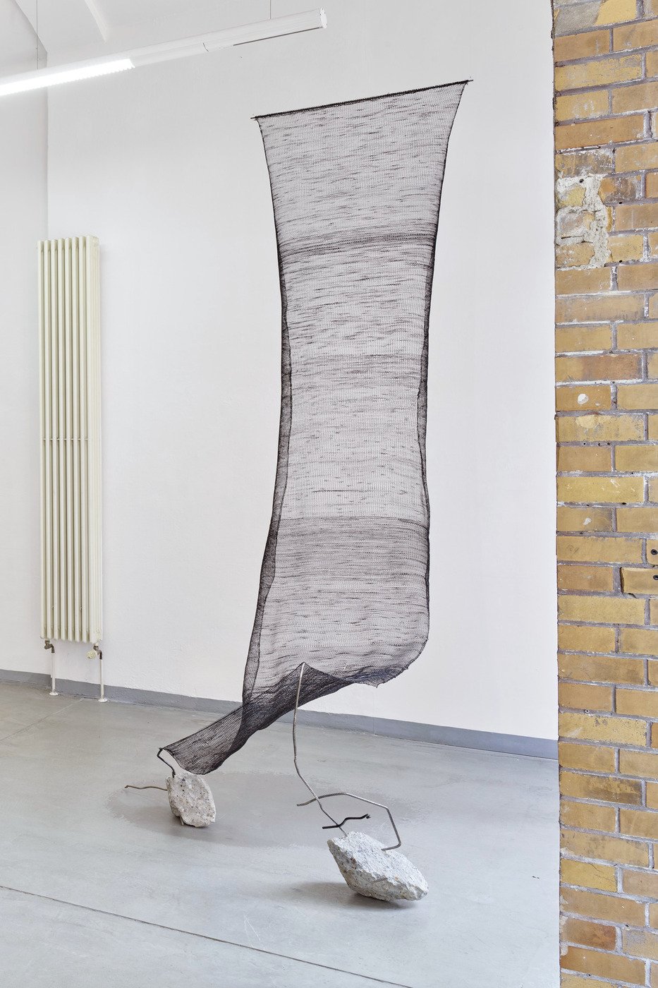 Suspended sculptural installation by Vanessa Enríquez exploring fragility, balance and transparency through woven material and 